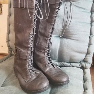 Gray knee high lace up boots.